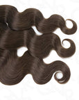Dark brown body wave crochet human hair extensions in feather texture, made from 100% human hair, showcasing smooth waves.